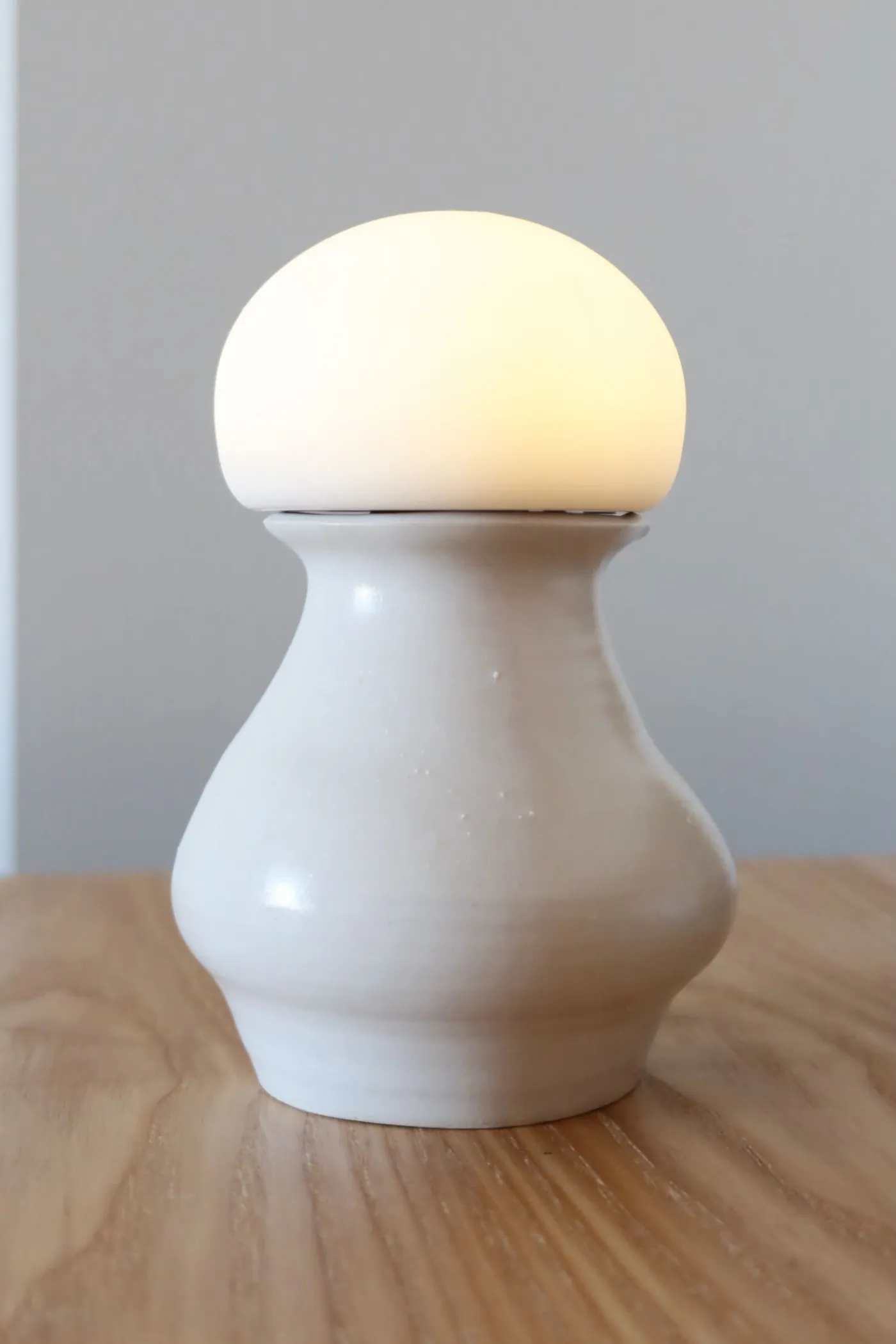 Photo of a ceramic vase with a light on top