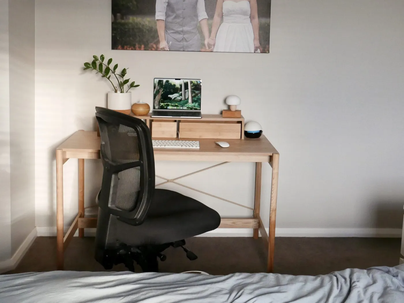Photo of my desk, showing my bed very close to it
