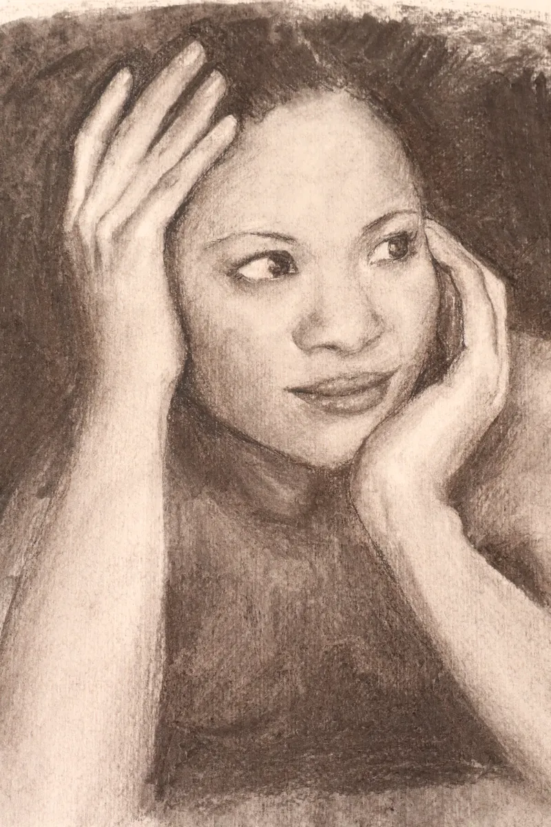 Charcoal portrait of woman with hands on her face