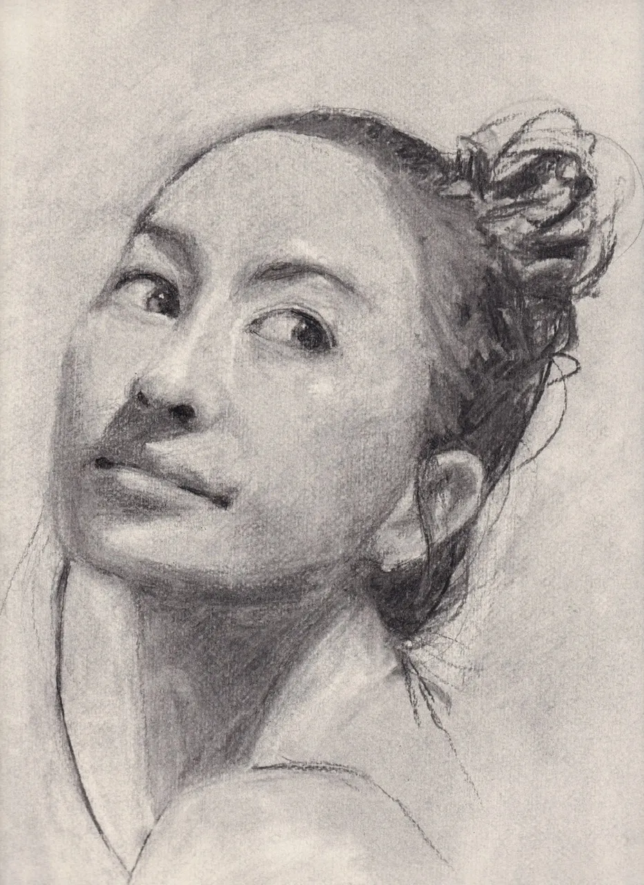 charcoal portrait of a woman looking over her shoulder