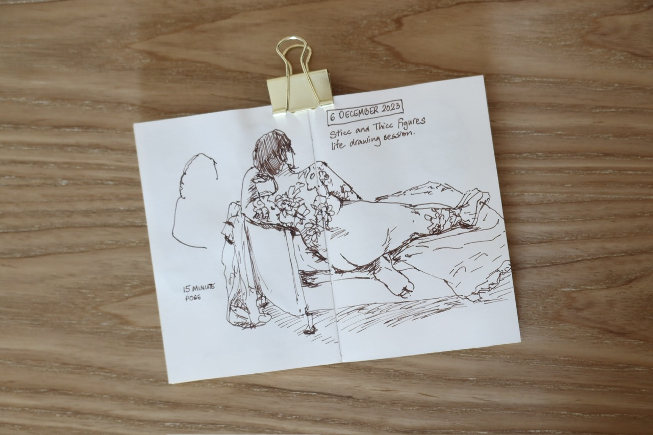 IMG_4730.jpeg|ink sketch of a nude tattooed woman reclining on a couch